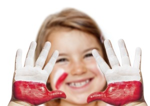 Fan happy girl with painted hands and polish flag